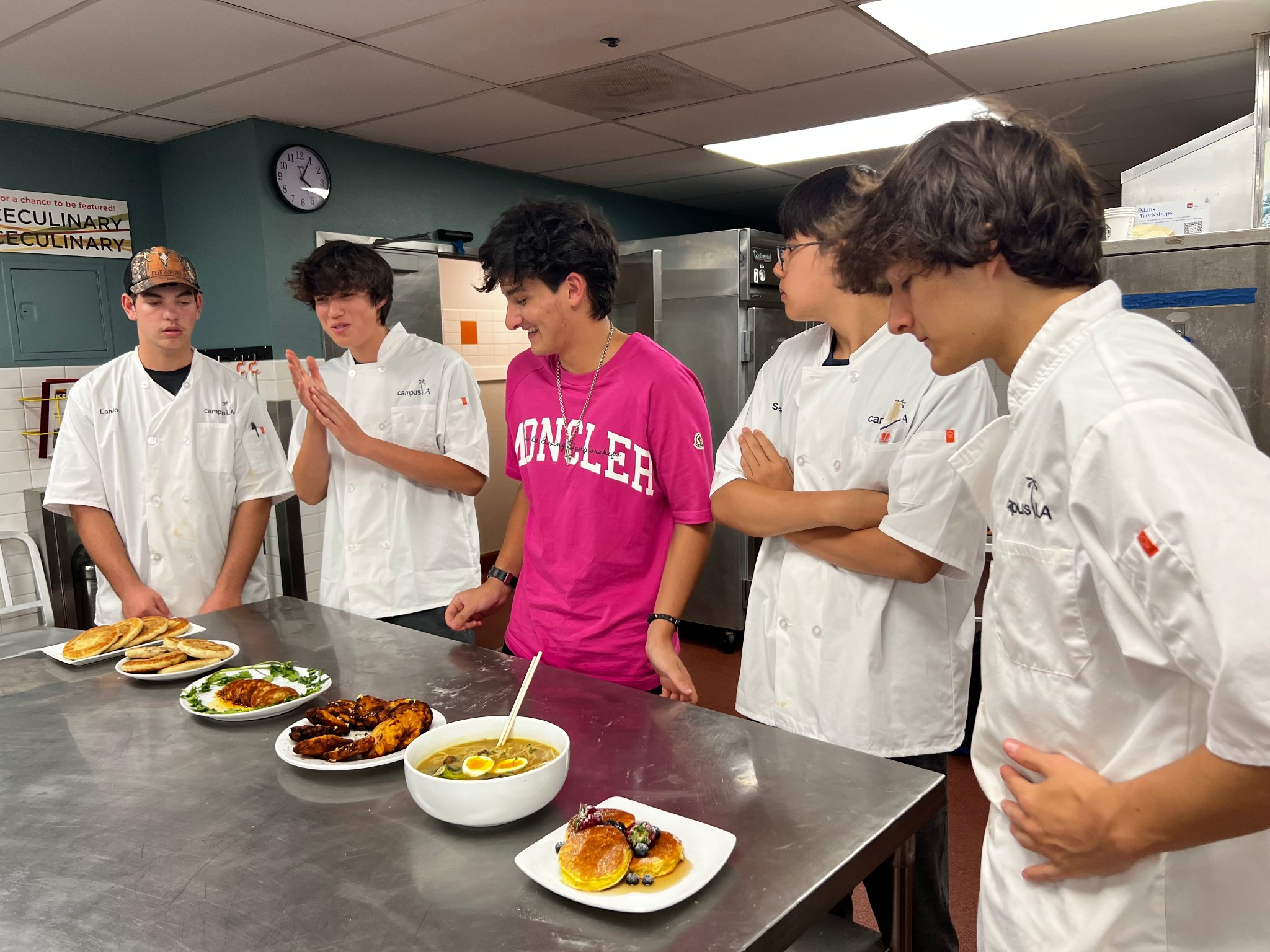 Teen campers reviewing their plated dishes with an instructor at campusLA